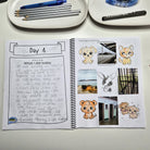 Completed kids travel journal page with guided prompts, photo spaces and travel memory activities